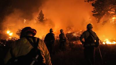 Wildfires scorch Southern California hillsides, burning homes and injuring 13