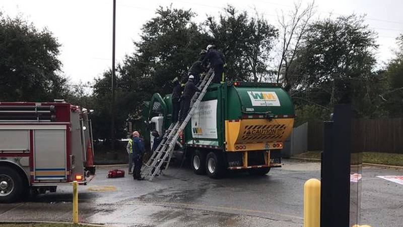 A person was rescued after they became trapped as a garbage truck in Escambia County, Florida was picking up trash from a dumpster.