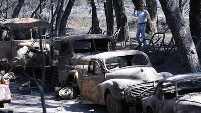 Wildfires scorch Southern California hillside homes. More are threatened