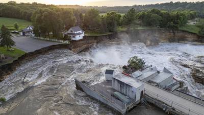 Swollen river claims house next to Minnesota dam as flooding and extreme weather grip the Midwest
